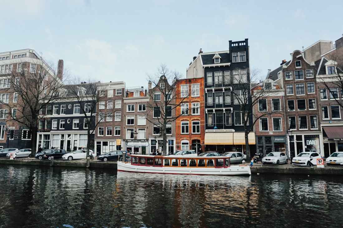white and brown wooden boat on body of water